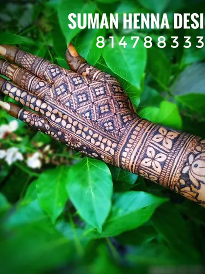 A geometric back-hand design featuring a lotus cuff at the wrist. This shows how traditional motifs can be used in a modern, structured pattern.