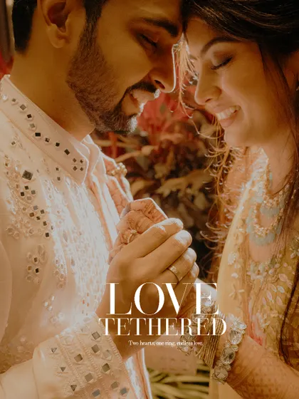 "Love Tethered". This close-up shot of the couple holding hands during their engagement ceremony beautifully symbolizes their new, unbreakable bond.