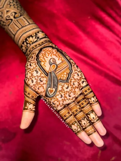 A gorgeous peacock design on the palm, with a heart detail in the center. The surrounding floral pattern is delicate and pretty.