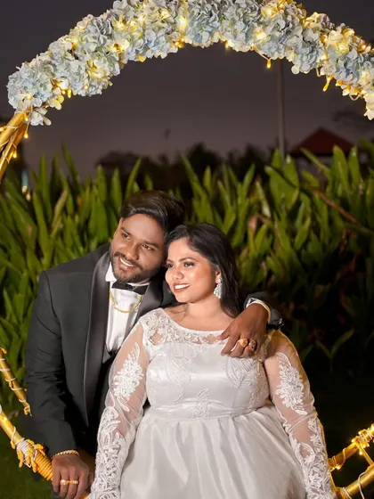 A close-up of a couple sharing a happy moment on a decorated swing during their evening pre-wedding photoshoot.
