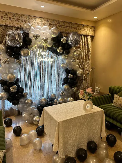 Another angle of the disco birthday setup, showing how it transforms a home space. The balloon arch and shimmering backdrop make a fantastic focal point for cake cutting and photos.