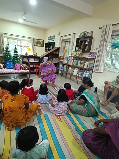 A wide shot of a storytelling session, showing how we utilize our entire space to create a comfortable setting.