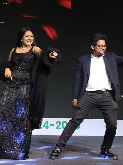 Even the hosts need to have some fun! Sharing a dance move on stage during the Housiey Annual Meet. It's all about keeping the mood light and celebratory.
