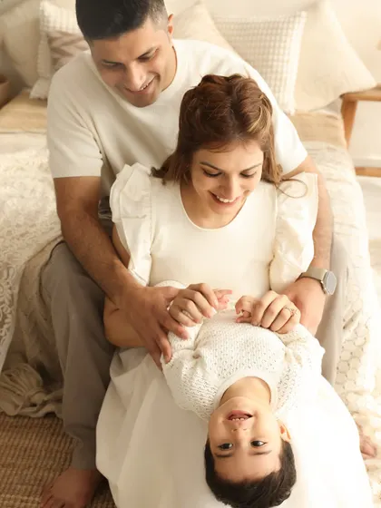 Upside-down smiles and playful tickles. This shot is all about the fun and games that make family life so special, captured in a bright and happy studio setting.