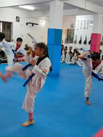 An instructor demonstrates a high kick.