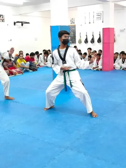 Two senior students demonstrate a form.