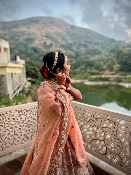 A beautiful shot of Varija overlooking the water. Her elegant hairstyle and radiant makeup complete this picturesque bridal moment.