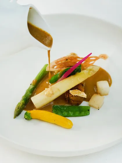 A rich, aromatic broth is poured over the elephant yam and asparagus in our vegetarian nihari, bringing all the elements of the dish together.