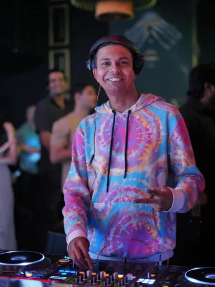 A candid, happy moment during the same set, interacting with someone just off-camera. It's all about personal connection.