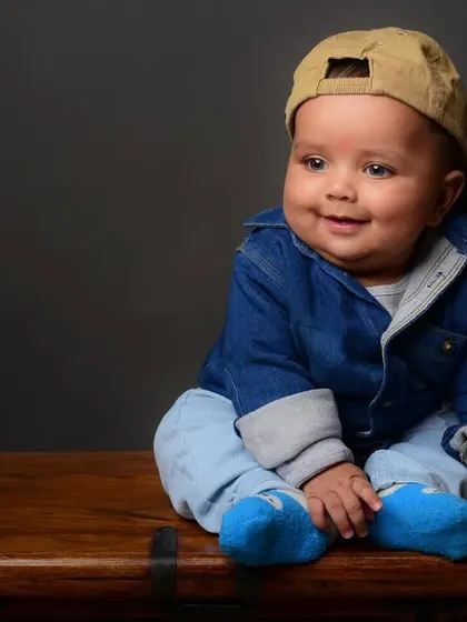 A cool and casual portrait of a baby boy, complete with a denim jacket and a cap. Props can add a lot of personality to kids' photos.