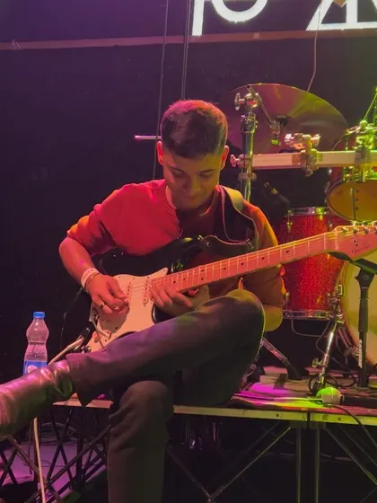 My guitarist, Aditya, absolutely shredding a solo. I love giving each of my band members their moment to shine on stage.