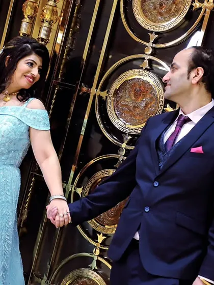 A happy couple holds hands during their engagement photoshoot. We focus on capturing the genuine connection and excitement between partners.
