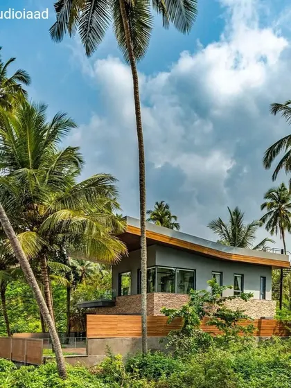 The Cove project in Goa is a private sanctuary designed to be in sync with its environment. The facade's clean geometric lines and native materials like wood and stone allow the home to blend seamlessly into the organic, tropical landscape.