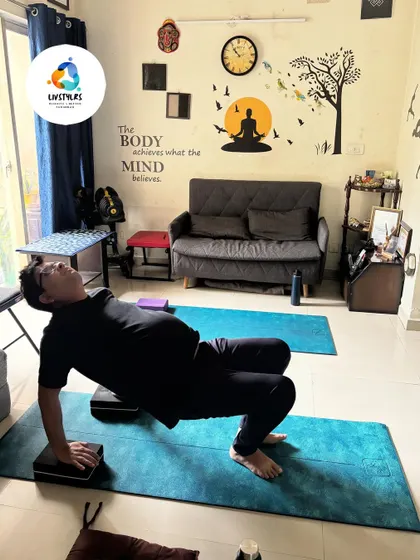 A client performs a modified table top pose, an excellent exercise for strengthening the glutes, hamstrings, and lower back. Using blocks under the hands can help with wrist comfort.