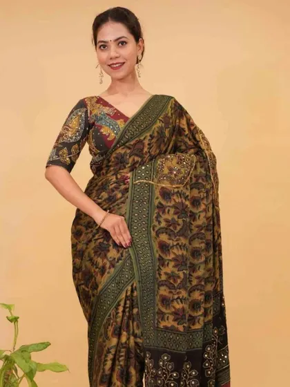 A beautiful Kalamkari print saree with intricate mirror work, pre-stitched for ease. This piece combines traditional art with a touch of sparkle, making it a unique addition to any wardrobe.