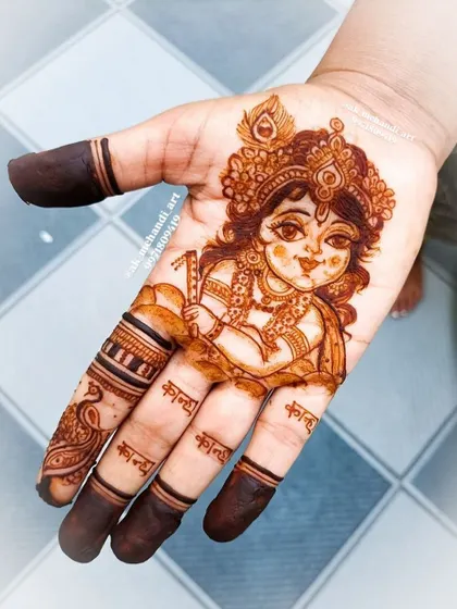 For special occasions like Janmashtami, clients often request themed designs. I teach how to draw figures like this beautiful portrait of baby Krishna, paying close attention to facial features and details.