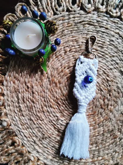 This evil eye bead macrame keychain is a pretty little accessory to ward off bad vibes. It can also be used as a bag charm and is customizable in different colors.