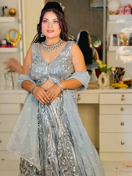 Dazzle at your next cocktail party or reception in this stunning silver sequin lehenga. The all-over sparkle and modern design make it a true showstopper, available for rent for your special night.