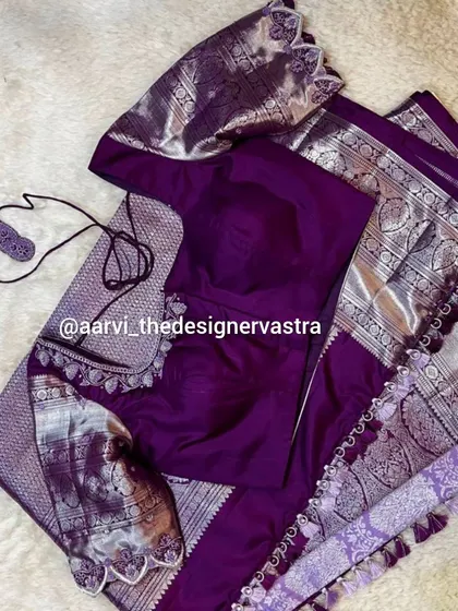 The full view of the purple blouse with its matching silver zari saree. A perfect outfit for a reception or evening event.