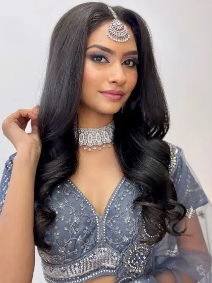 A classic silver and black smokey eye paired with a nude pink lip. This is a timeless reception look that you will master.