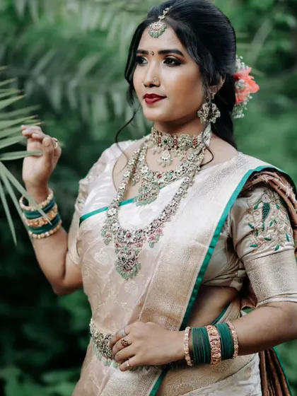 Client Priyanka looking radiant in a multi-hued Victorian jewellery set. The combination of red and green stones with a silver finish offers a vibrant look for receptions and parties.
