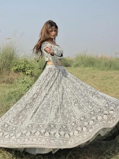 The twirl shot every girl dreams of. This image captures the magnificent flare of the heavily embroidered black and white lehenga skirt.
