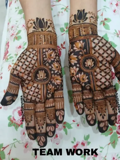A lovely design by my team, combining lotus mandalas with intricate check patterns. It's a balanced and beautiful look for any festive occasion.