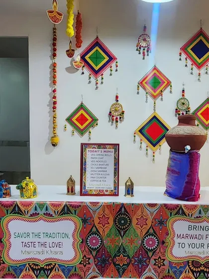 To complement a Marwadi-themed office celebration, I styled this food counter to perfection. The decor includes a colorful patterned table skirt, traditional Rajasthani wall hangings, and a decorated matka, creating an authentic and immersive experience for the employees.