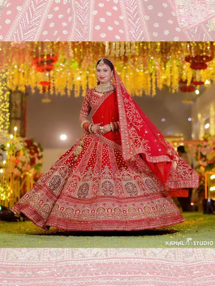 A magnificent full-length shot of the bride, her red lehenga spread out, showcasing its intricate embroidery.