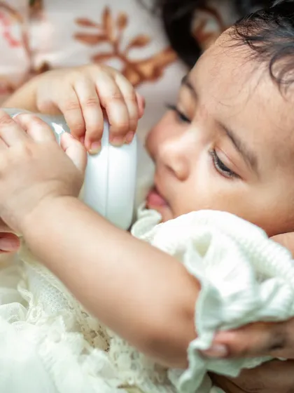 A close-up of a newborn feeding, a simple yet profoundly intimate moment. I focus on capturing these real, unposed details of early parenthood.