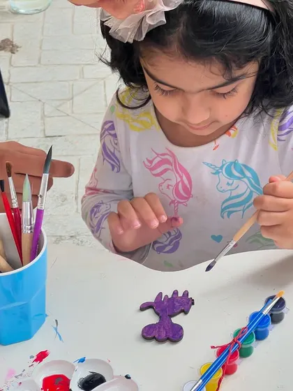 A little one getting some gentle guidance as she paints a wooden dragon. We are always on hand to help and encourage the children as they create.