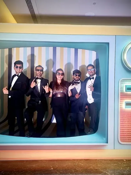 A fun band photo inside a retro TV prop at a corporate gig at JW Marriott. We always embrace the creative themes of the events we play at.