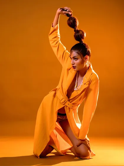 A high-fashion editorial I conceptualized called "The Yellow Fever." This look features a dramatic, sculptural bubble ponytail and a yellow trench coat, creating a unique and artistic fashion statement.