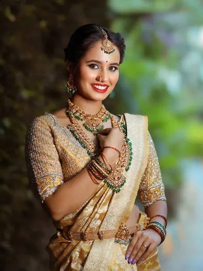 The full bridal ensemble, showcasing the rich texture of the Kanchi tissue saree and the detailed embroidery on the blouse.