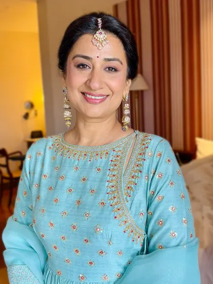 Her smile radiates pure happiness. The makeup is designed to enhance her natural beauty without feeling heavy, ensuring she feels comfortable and confident.
