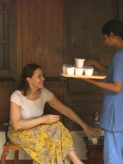 A therapist serves a guest her prescribed herbal drink with a warm smile. We believe that care and kindness are essential ingredients in the healing process.