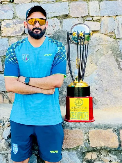 Standing with a championship trophy. This is the goal we work towards every single day, a symbol of dedication, teamwork, and relentless effort.
