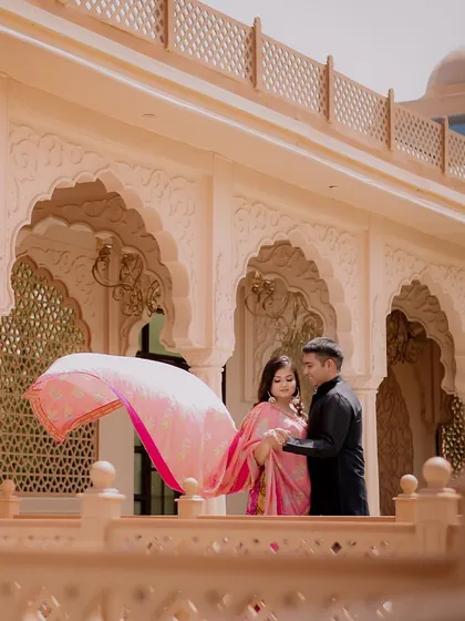 A playful moment with the bride's dupatta catching the wind, adding movement and life to this pre-wedding photo.