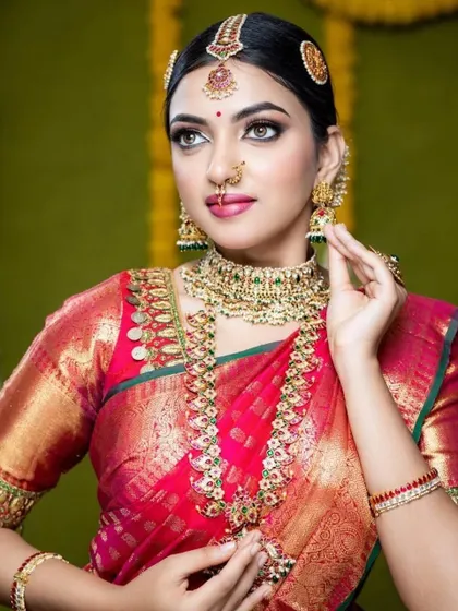 A classic bridal look featuring a kemp stone set. The red and green stones are a timeless combination for South Indian brides.
