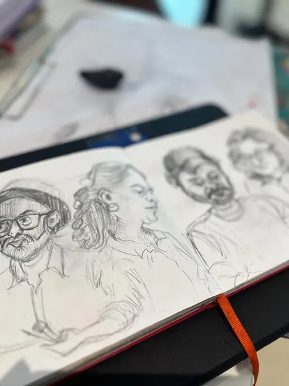 A page from my sketchbook featuring pencil caricatures of my artist friends, captured during one of our sketch walks.