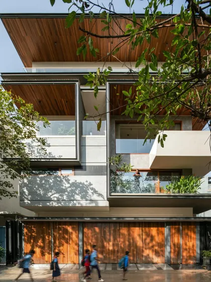 The Timber Edge facade is a composition of projecting and receding volumes, including a prominent cantilevered balcony. This structural play adds depth and dynamism to the building's exterior.