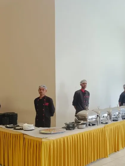 A buffet setup with elegant yellow table skirting for a wedding anniversary party at Prestige Song of the South.