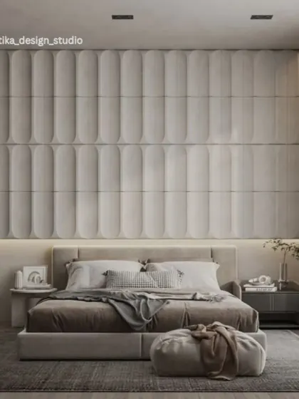 This luxurious bedroom features a stunning floor-to-ceiling upholstered wall with curved, fluted panels. The neutral tones, layered textiles, and soft ambient lighting combine to create an exceptionally serene and sophisticated retreat.