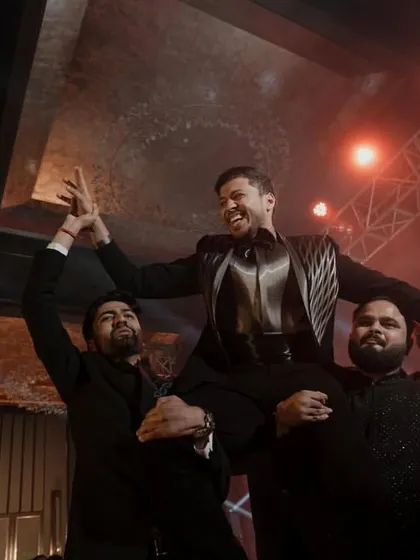 The groom celebrating with his friends after a high-energy performance. These are the moments of pure joy and celebration that make a sangeet night.
