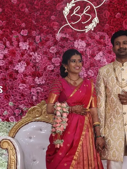 Here is a happy couple posing against a dense flower wall of pink and white roses. I also added their custom neon monogram to the backdrop for a personal touch, making their reception stage unique to them.