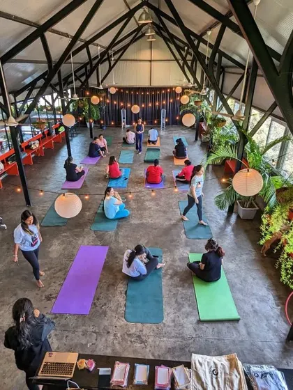 An overhead view of our puppy yoga class. Look at all the colorful mats, happy people, and adorable pups. This is what community and unconditional love look like.