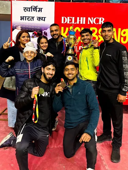 The team celebrating with our trophy at the Delhi NCR Kickboxing Cup.