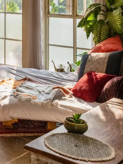 We use colorful textiles and cushions to add personality and comfort. The mix of reds, blues, and earthy tones creates a playful and inviting atmosphere.