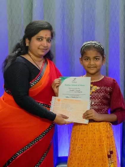 A student is awarded her certificate after passing her graded exam. I celebrate every milestone in my students' musical journeys.