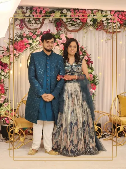 A full view of this stunning couple. The groom's teal sherwani adds a pop of color, making them stand out at their event.